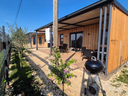 a house with a grill on the front of it at Hiška Morska ravnica in Sveti Petar