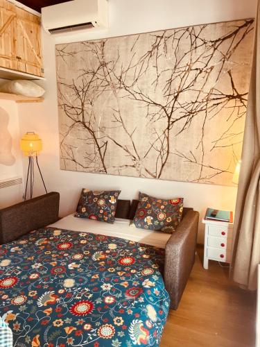 a bedroom with a bed and a painting on the wall at Cottage by the Lake in Balatonudvari