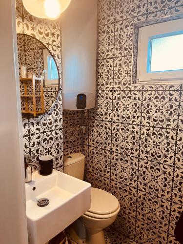 a bathroom with a sink and a toilet and a mirror at Cottage by the Lake in Balatonudvari
