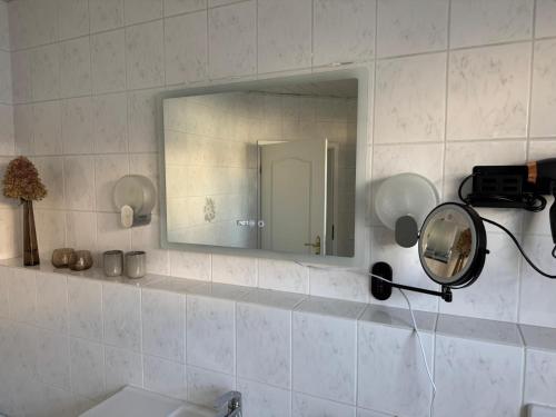 a bathroom with a mirror and a sink at AhA in Lingen