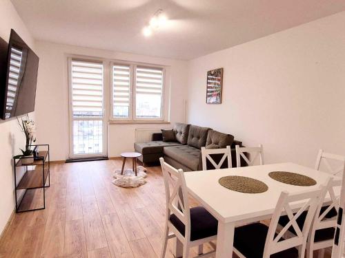 a living room with a table and a couch at HappyStay View in Gliwice