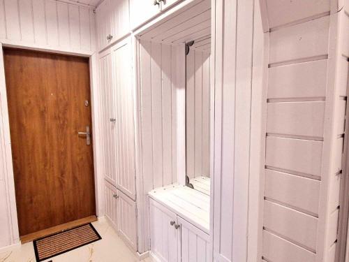 a room with white walls and a wooden door at HappyStay View in Gliwice