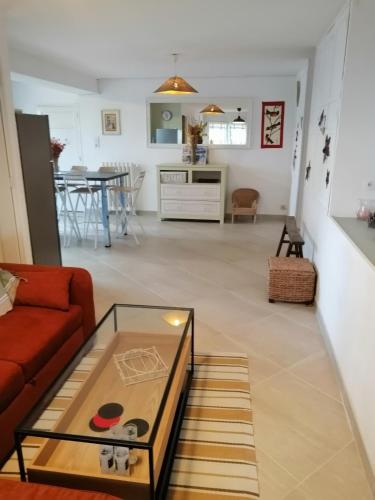 un salon avec un canapé rouge et une table en verre dans l'établissement Aqui siem ben, à Sète