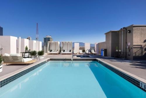a large swimming pool on top of a building at Huge Downtown LA Loft with Rooftop Pool & Jacuzzi in Los Angeles