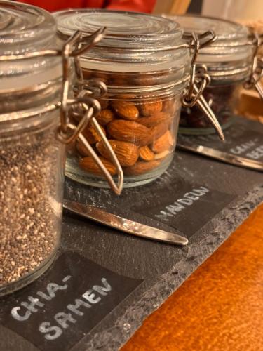 a jar of nuts sitting on top of a table at Amical Hotel Hagen - Am Hauptbahnhof in Hagen