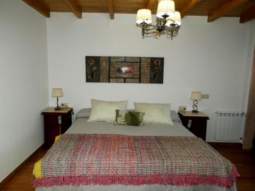 a bedroom with a large bed with two night stands at Casa Daniel in Riberas del Sor