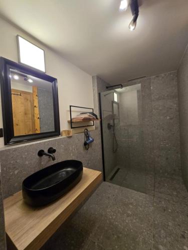 a bathroom with a black sink and a shower at Corso Harrachov Apartment 303 in Harrachov