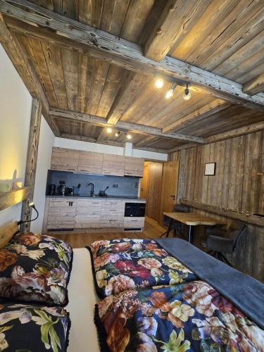 a bedroom with two beds in a room with wooden ceilings at Corso Harrachov Apartment 303 in Harrachov