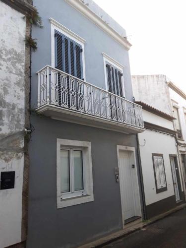 a building with a balcony on the side of it at Vila Nova Suite Apt (historic PDL city center) in Ponta Delgada