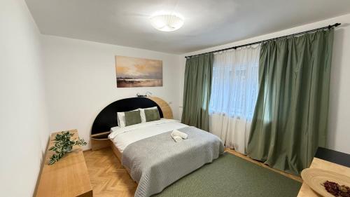 a bedroom with a bed and a large window at Felix 41 - Piata Victoriei, Near Metro - RH Living in Bucharest