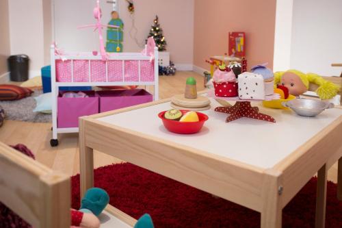 a table with toys on it in a play room at Hôtel Club mmv Les Arolles **** in Val Thorens