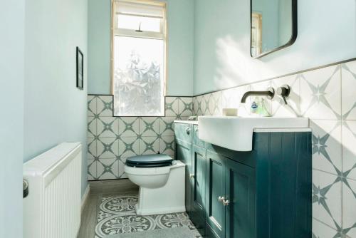 a bathroom with a toilet and a sink at The Prince's Eyrie - Spacious, comfy and cosy in Bishop Auckland
