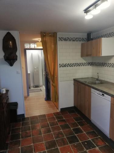 a kitchen with a sink and a counter top at maison des trois rivières in Trévières