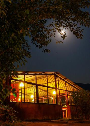 a building at night with the moon in the sky at Mysticstays Resort in Wai