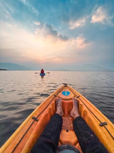 a persons feet on the front of a boat in the water at Mysticstays Resort in Wai