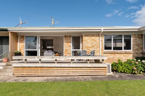 a house with a wooden deck in front of it at Mount Central Hideaway in Mount Maunganui
