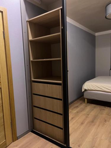 a closet with a mirror in a room with a bed at Mare et Ventus in Ventspils