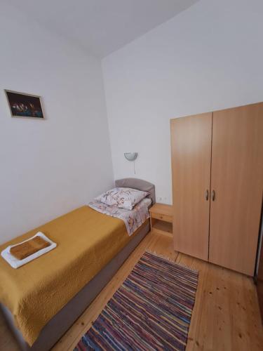 a small bedroom with a bed and a cabinet at Bernarda in Sveti Vid-Miholjice