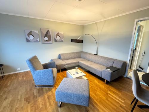 a living room with a couch and two chairs at Apartment with a beautiful view in the center of Ålesund in Ålesund