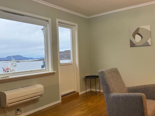 a living room with a chair and a window at Apartment with a beautiful view in the center of Ålesund in Ålesund