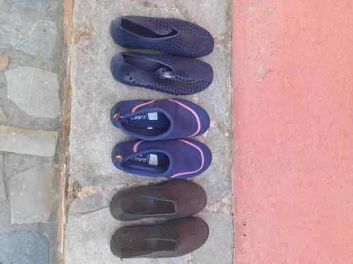 a group of shoes sitting next to a wall at Δωμάτια Κόκκινος Πύργος in Plomarion