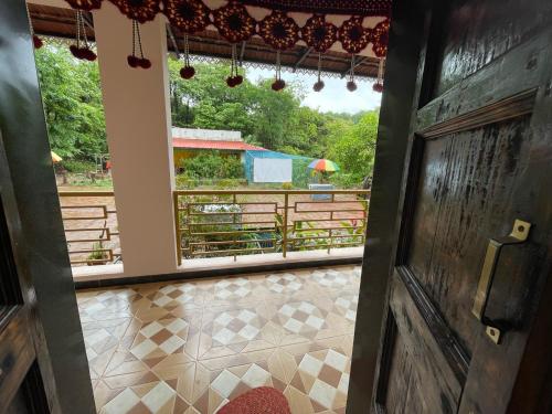 a view from the door of a room with a view at hornbill homestay in Pendur