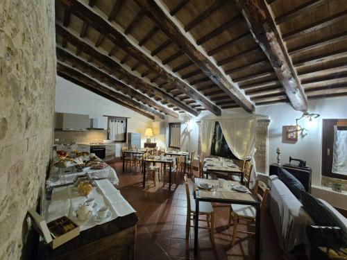a living room with tables and chairs in a building at Casale Delle Stelle in Castello delle Forme