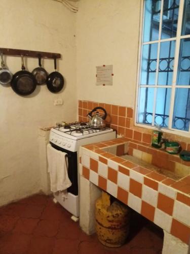 a kitchen with a stove and a sink at Casita d Playa 1 in La Esmeralda
