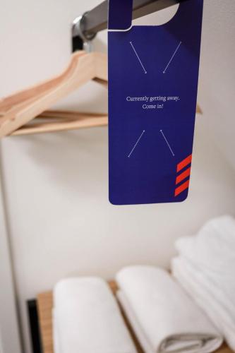 a blue bag hanging on a wall next to towels at schlossmühle - lean luxury boutique hotel in Glottertal