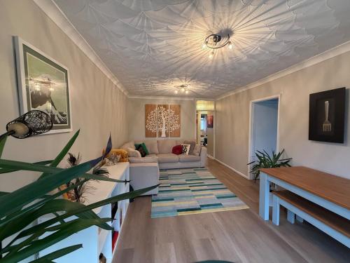 a living room with a couch and a table at Bright Pearl in Weston - A Sanctuary in Weston-super-Mare
