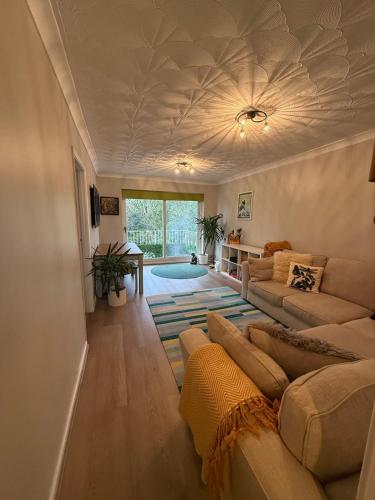 a living room with a couch and a ceiling at Bright Pearl in Weston - A Sanctuary in Weston-super-Mare