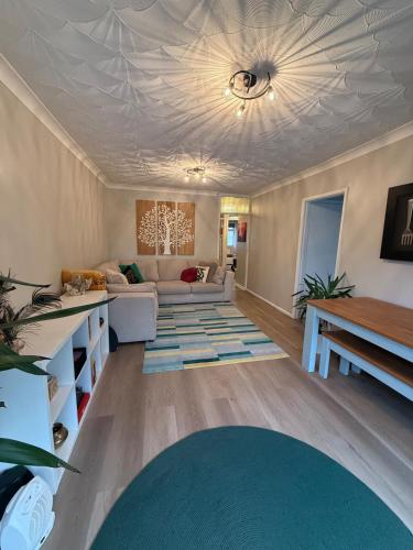 a living room with a couch and a ceiling at Bright Pearl in Weston - A Sanctuary in Weston-super-Mare