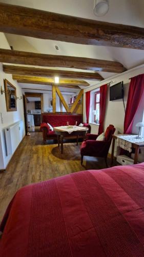 a bedroom with a bed and a table and a couch at Historisches Apartment in Mühlhausen Thuringia in Mühlhausen