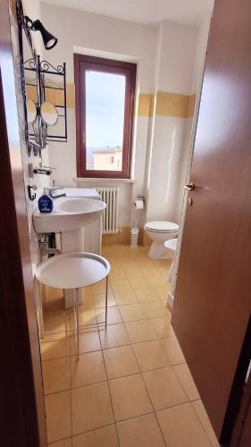 a bathroom with a sink and a toilet at The Little House in Rieti