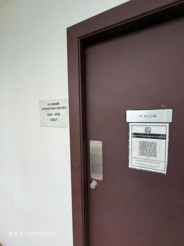 a brown door with a tv room sign on it at Vivacity Jazz Suites Kuching by REA Homestay in Kuching