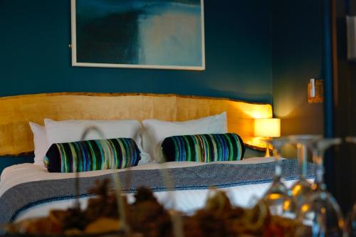 a bedroom with a bed with two pillows at Arosfa Harbourside Aberaeron in Aberaeron