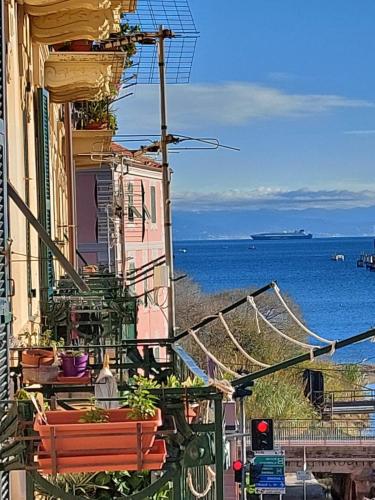 a building with plants on the side of it next to the ocean at CasAda - Ampio appartamento con vista mare nel cuore di Vado Ligure in Vado Ligure