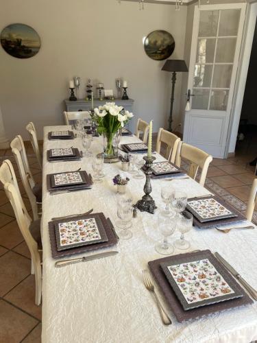 a long table with plates and dishes on it at Le Balcon De Roxane in Malaucène