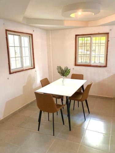 a dining room with a white table and chairs at Villa Elena - Private Room in Carenero