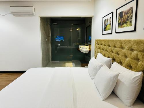 a bedroom with a large white bed with white pillows at Beverly Beach Mirissa in Mirissa