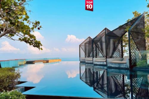 a rendering of a swimming pool with the reflection in the water at EDGE Sea View Holiday inn Pattaya Central in Pattaya
