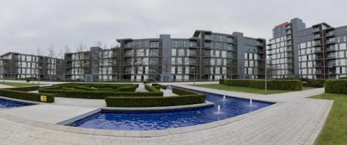 a courtyard with some bushes and some buildings at Vizion Suites Milton Keynes - Free WiFi, Netflix Secure, Parking, Fully Furnished & Equipped Apartments in Milton Keynes