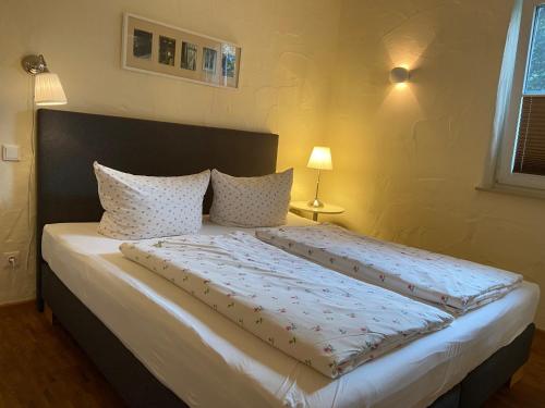 a bed with two pillows on it in a bedroom at NaturApartments - Hideaway & Spa in Burg