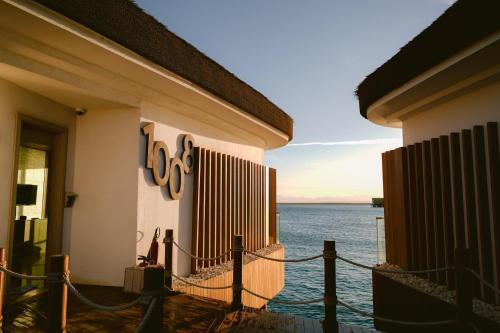 a building with a sign on it next to the water at Tawila Island Resort in Hurghada