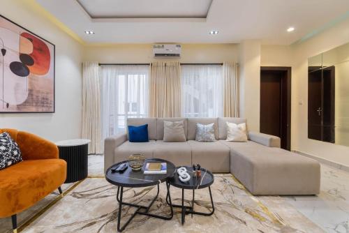 a living room with a couch and a table at Sugary in Ogoyo