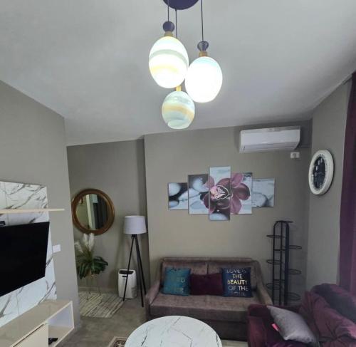 a living room with a couch and two lights at Blue View Apartment in Himare
