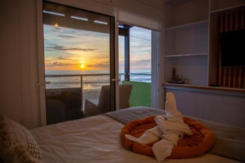 Un dormitorio con una cama con vista al mar. en Wave Shadows Beach House Oceanfront property - Top Floor, en Paul do Mar