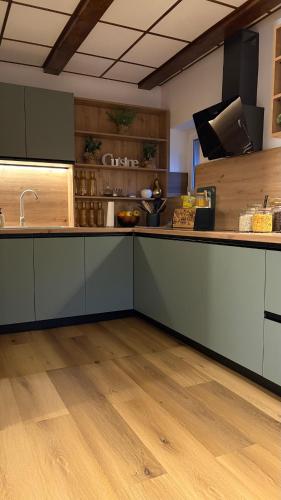 a kitchen with a large counter top with wooden floors at Casa Cristina in Braşov