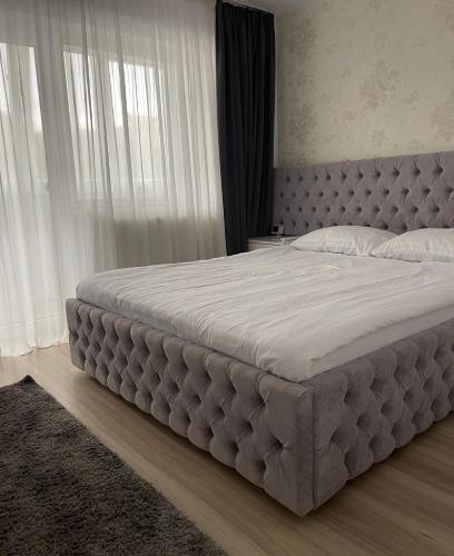a large bed in a bedroom with a large mattress at Anca Home in Petroşani