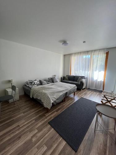 a white room with a bed and a couch at Cozy Nilsiä Apartment in Nilsiä